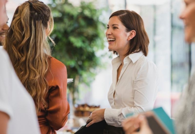 Smiling woman talking with others in a Brain Health Programme workshop in Edinburgh